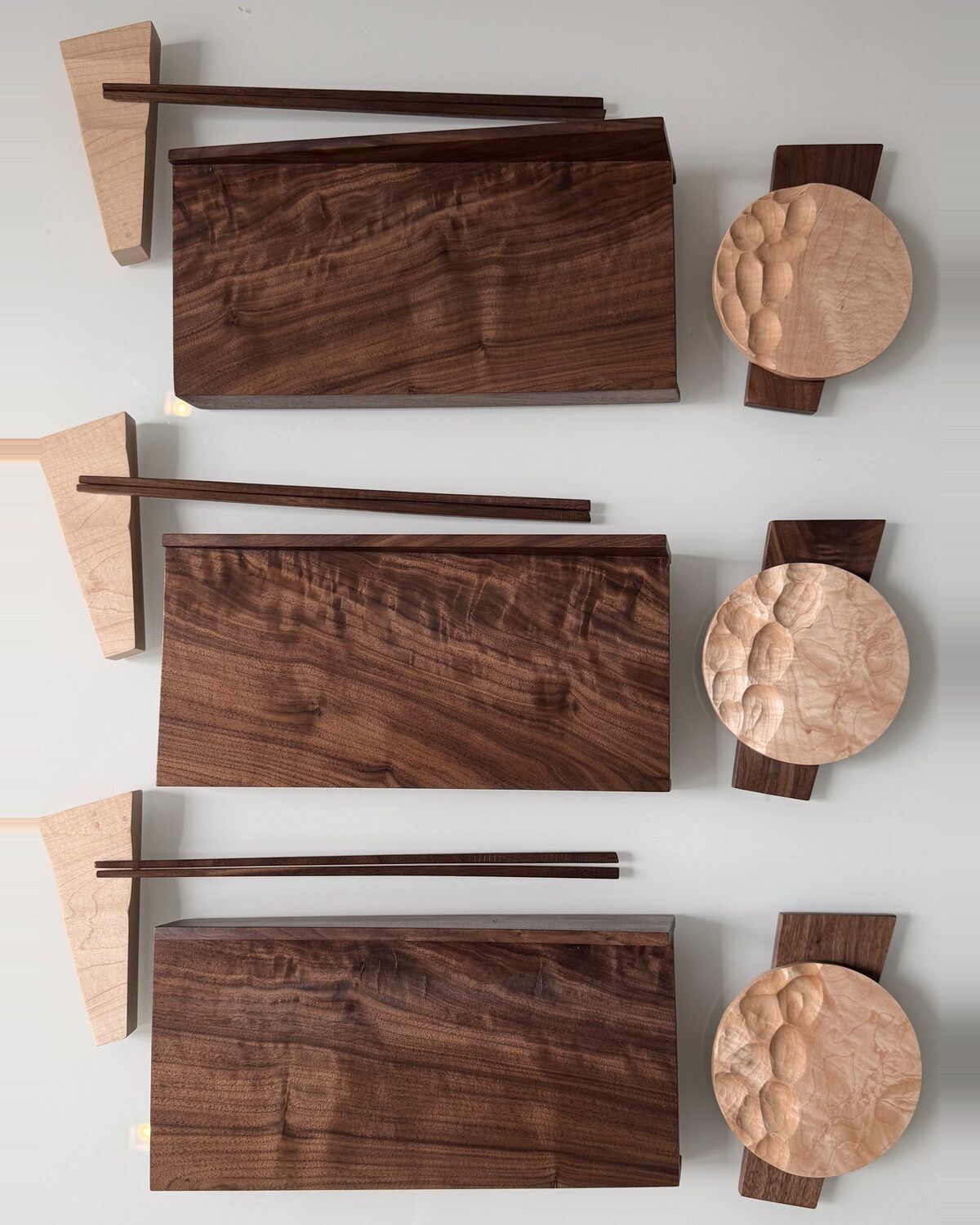 Walnut boards and carved maple dishes, seen from above