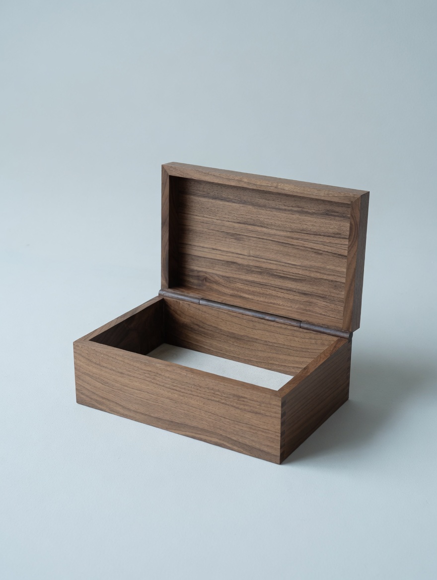 A hinged walnut box, opened
