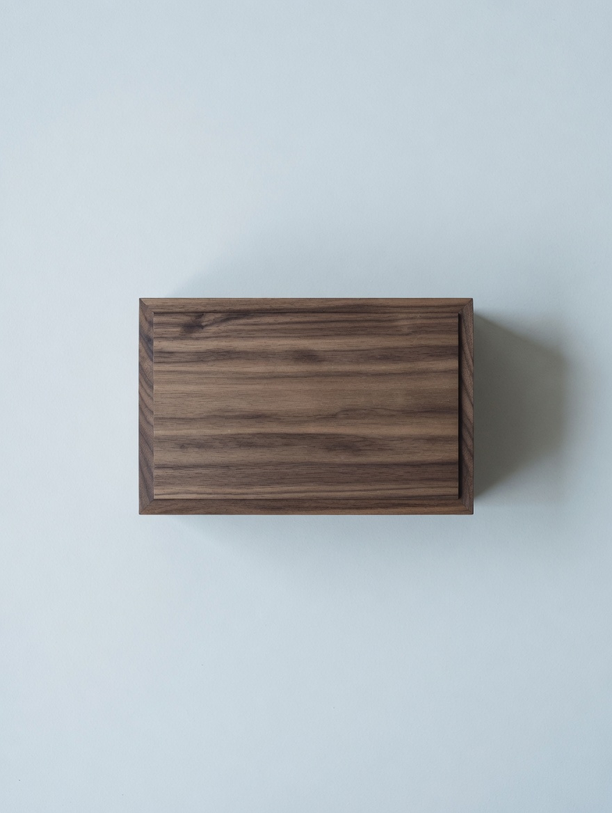 A walnut box with sliding lid